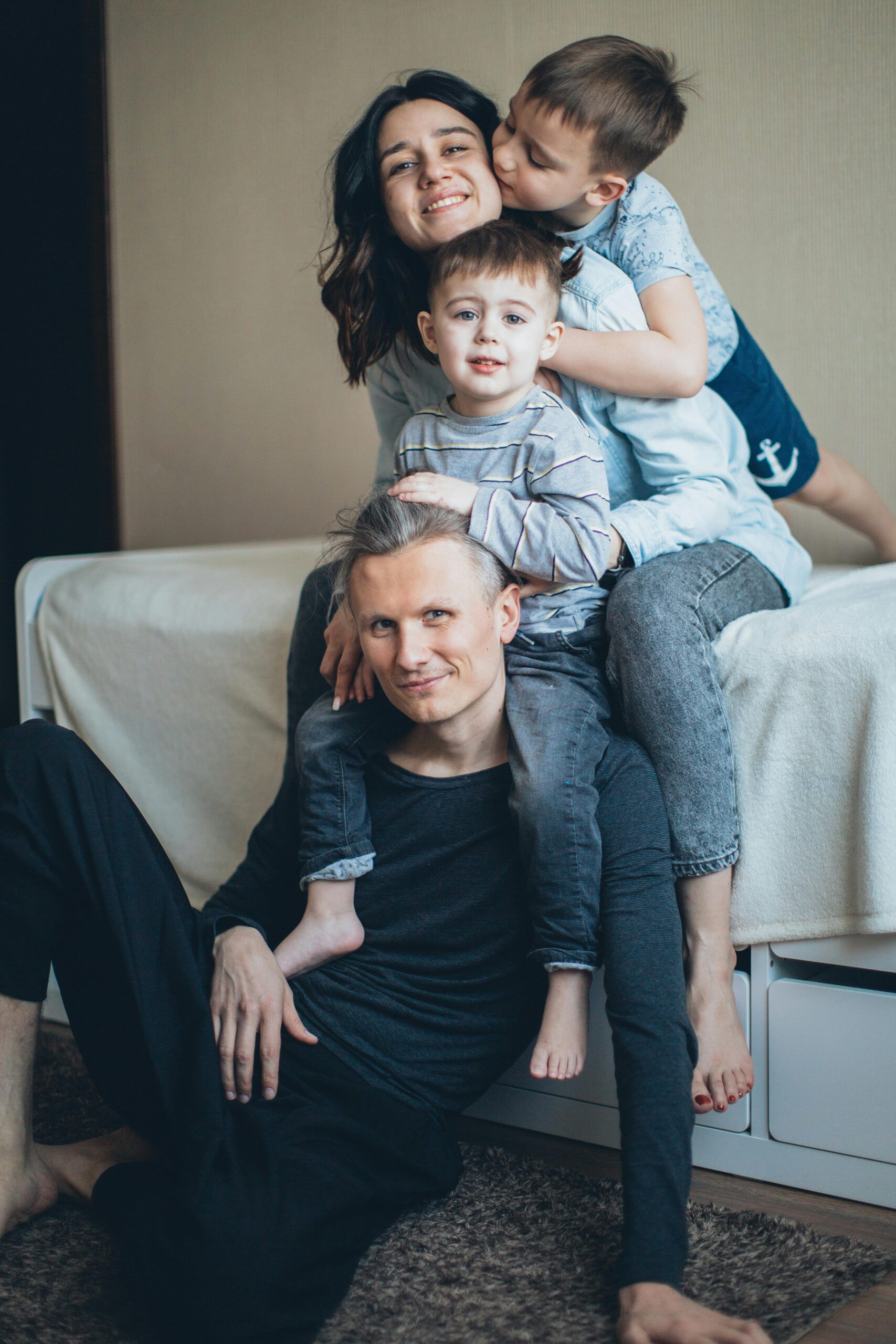 A joyful family bonding in a cozy indoor setting, capturing love and togetherness.